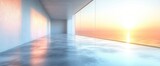 Room with sunset ocean view from windows. Light reflects on interior walls and shiny concrete floor