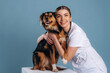 © standret - Embracing the animal, smiling. Woman veterinarian is with mixed-breed dog