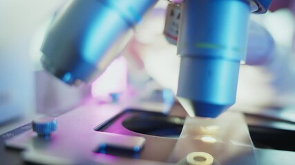 Wall Mural - laboratory technician meticulously adjusting microscope lenses, illuminating specimens with focused 