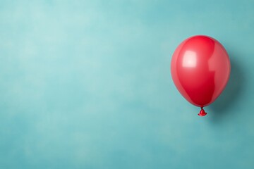 Leinwandbilder - Vibrant red balloon with a glossy finish positioned on the left, creating a cheerful atmosphere against a soft pastel blue background with room for text
