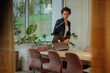 © bernardbodo - Businesswoman sitting down inside of the glass office