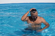 © aaalll3110 - A man in sunglasses swims in a blue pool. Vacation at the hotel by the sea, sunset and mountains. Happy dad, family happiness. Muscles and a beautiful figure, black hair. High quality photo