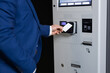 © zinkevych - Man paying for parking with wireless card scanning in transport facility