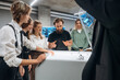 © standret - Group of people are standing around the 3d printer in office
