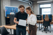 © standret - Man and woman are standing. Designer team are together in the office