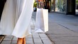 © ShantiMedia - Sophisticated woman walking downtown sidewalk, dressed in billowing designer dress, holding luxury shopping bag, representing urban chic elegance