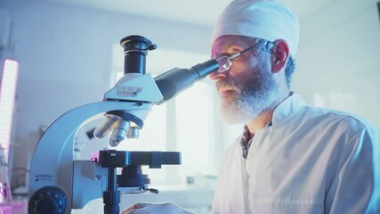 Wall Mural - laboratory professional wearing protective gear analyzing scientific samples through microscope whil