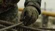 © Allie - Construction worker securing rebar for concrete foundation. Featuring attention to detail and strength