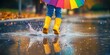 © Alokya - A child jumps in puddle while wearing yellow rain boots