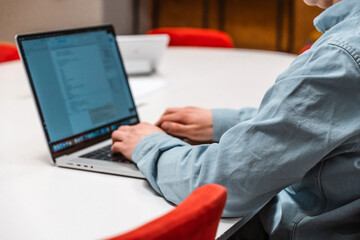 Canvas Print - a man it specialist, a businessman in a shirt working on a laptop in office, a code development conc