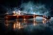 © andrei - A violin lies on a reflective surface, surrounded by sparks and smoke in a dimly lit setting, creating a dramatic atmosphere.