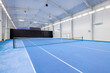 © Mindaugas Dulinskas - Indoor Tennis Court With Blue Surface and Bright Lighting for Sports Activities