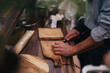 © qunica.com - A chef skillfully preparing food on a wooden cutting board in a cozy kitchen. The warm atmosphere and focus on culinary techniques highlight a modern yet homely food preparation scene.