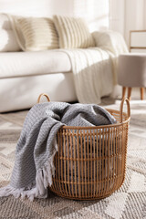 Poster - Wicker basket with gray blanket in living room