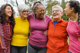 Multi generational women having fun hugging each other at city park - Multiracial group of people outdoor - Social inclusion and community concept