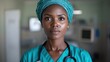 ©  Shomixer - A nurse poses confidently in teal scrubs and a surgical hat, symbolizing care, dedication, and professionalism in a modern hospital environment for patients.