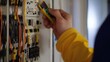 © Mcgui - Electrician testing electrical circuits in a panel box. Featuring technical skill and expertise