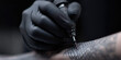 © dinastya - Tattoo artist with black gloves draw tattoo on skin with tattoo machine. Tattoo artist's workflow