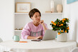 © mary_markevich - attractive woman sitting at home at table working on laptop