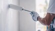 © keshia - Interior painter applying a fresh coat of paint on a wall. Featuring smooth application and precision