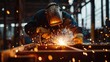 © Mcgui - A construction worker welding metal parts for a steel frame. Featuring welding and metal fabrication