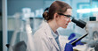 © peopleimages.com - Microscope, woman and scientist in laboratory for medical research, discovery or project on organisms. Biotechnology, goggles and female biologist with equipment for DNA review for innovation.