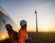 © Westend61 - Engineer with tablet observing wind turbine at sunset