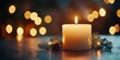 © Vangly - A lit candle surrounded by pine branches and warm bokeh lights.