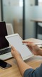 © Neuroillustrator3033 - Person using tablet with stylus in modern office