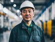 © Joesunt - Focused and Determined: A seasoned engineer, clad in a safety helmet and work attire, stands confidently in a factory, embodying the essence of precision and industrial expertise.