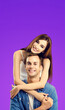 © vgstudio - Portrait vertical image - smile cute young couple boyfriend girlfriend, beautiful woman, man in blue denim shirt cloth isolate violet purple background. Happy love concept. Banner with free text space