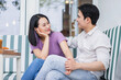 © Timeimage - Couple enjoys a cozy conversation at a cafe on a sunny afternoon with a relaxed atmosphere
