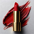 © Chanyapat - Luxurious red lipstick with sleek gold casing, placed on textured surface with bold red smear. This captures elegance and beauty, perfect for cosmetic promotions