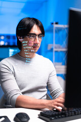 focused software engineer coding at workstation, illuminated by blue light, with code reflecting on 