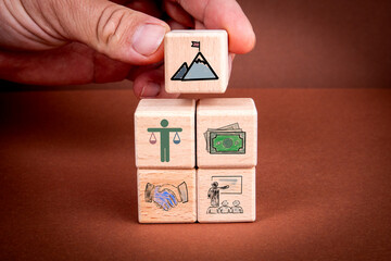 Wall Mural - Business Concept with Wooden Blocks Representing Justice, Money, Agreement, and Education