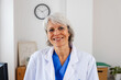 © Xavier Lorenzo - Portrait of middle aged healthcare worker standing at doctor's office. Head shot of senior female doctor at her workplace in hospital.