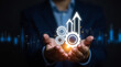 © Kamran - Process improvement and productivity growth concept. A businessman holds gears and upward arrows, symbolizing process optimization, productivity growth, efficient processes, and business efficiency.