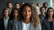 © Alfanachmad - Confident businesswoman surrounded by her successful team, showcasing leadership and collaboration in a modern office environment.