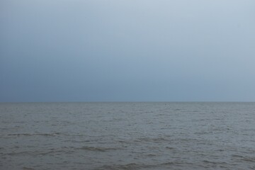 Wall Mural - landscape of sea on sunset with rain cloud coming