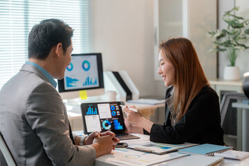 Poster - Asian businesspeople discussing statistics graphs on tablet and desktop computer in office meeting room