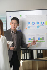 Fototapete - Businessman explaining graphs during a meeting