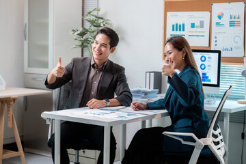 Poster - Asian businesspeople showing thumbs up while working together in office