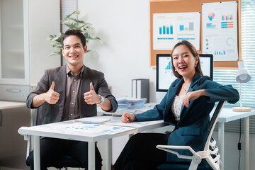 Poster - Asian businesspeople showing thumbs up while working together in office
