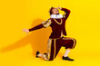 © deagreez - Male actor dressed as a nobleman in a red costume posing on yellow