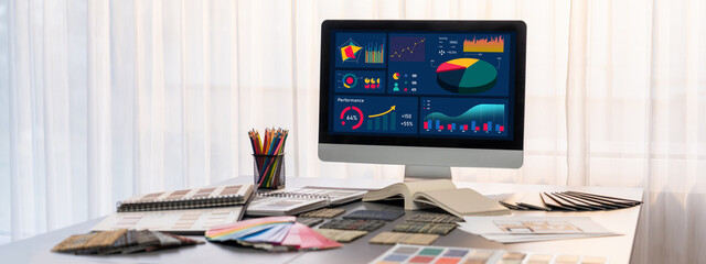 Interior designer workspace table and architecture software on laptop screen with mood board materials and colorful swatch color for color selection. Modern interior design office. Insight
