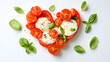 © Petro - Fresh and vibrant heart-shaped salad with tomatoes and mozzarella, garnished with basil leaves.