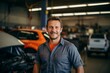 © NikoG - Middle Aged Caucasian car mechanic in a car mechanic shop smiling portrait
