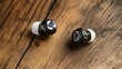 © Elshad Karimov - Sleek wireless earbuds in white and black offer high-resolution audio.  A trendy, minimal design, perfect for laptops and phones.  Enjoy comfortable listening on a wooden table.