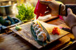 © Marko Geber - Chef garnishing sushi rolls with sauce at restaurant kitchen counter