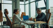 © Kostiantyn - Business discussion in modern glass office setting